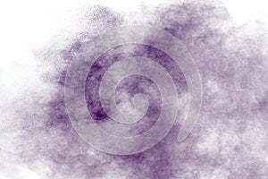 Purple particles explosion on white background. Freeze motion of purple dust splash on background.Purple particles explosion on