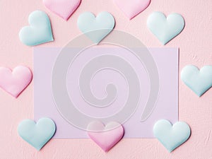 Purple pastel card and hearts on pink textured background