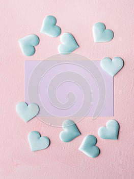 Purple pastel card and hearts on pink textured background