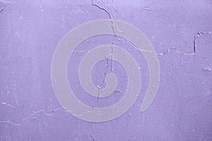 Purple peeling paint in several layers on the metal, rusty surface background