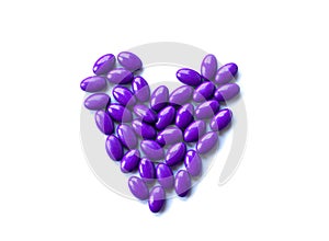 Purple pills on white background isolated