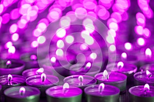 Purple pink candle light. Christmas or Diwali celebration tealight candlelight. Christmas vigil lights photo