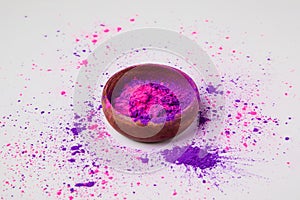 Purple and pink holi powder in bowl