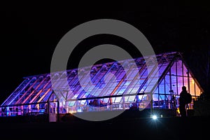 Purple and Pink Lights Illuminating an Alpine Greenhouse.