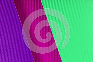 Purple, pink and mint colored corrugated paper texture. Geometric shapes and lines.