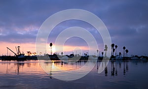 Purple and pink sunrise sky over Channel Islands harbor in Port Hueneme on the gold coast of California USA