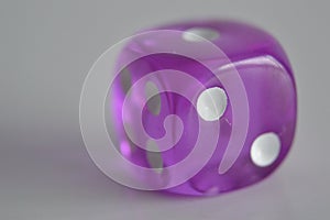 Purple plastic arcylic d6 six sided die dice close up variable focus