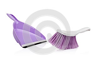 Purple plastic scoop with white rubbish cleaning brush isolated on white background. Household products.