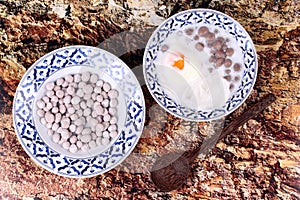 Purple potato dumplings with poached egg and coconut roll in sweet coconut cream .