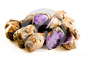 Purple potatos on white
