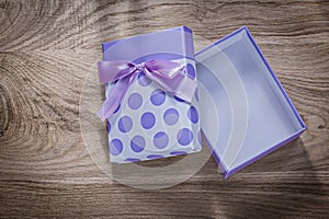 Purple present box with tape on wooden board celebrations concep