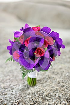 Purple and red flowers wedding bouquet on the beach