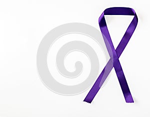 Purple ribbon as a symbol of women's struggle, fight against gender violence and cancer survival