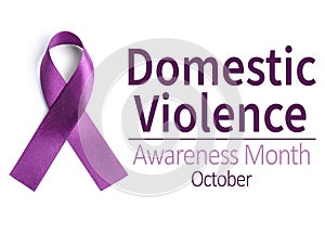 Purple ribbon on background, top view. Symbol of Domestic Violence Awareness