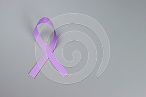 purple ribbon on a gray background, Symbol of the fight against domestic violence