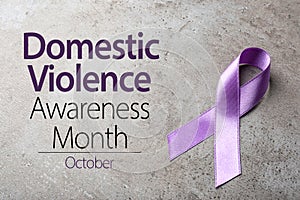 Purple ribbon on background. Symbol of Domestic Violence Awareness photo