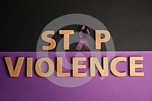 Purple ribbon and phrase STOP VIOLENCE on background, flat lay