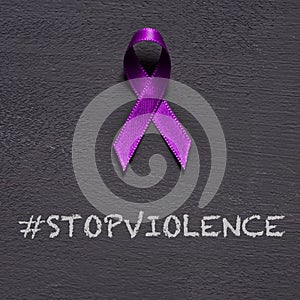 Purple ribbon and text stop violence