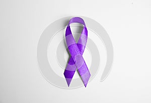 Purple ribbon on white background. Domestic violence awareness