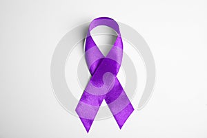 Purple ribbon on white background. Domestic violence awareness