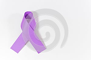 Purple ribbon on the white surface - awareness of violence against women concept