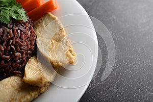 Purple rice berries cooked with grilled chicken breast. Pumpkin, carrots, and mint leaves in a dish, clean food