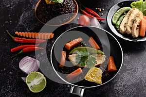 Purple rice berries cooked with grilled chicken breast. Pumpkin, carrots, and mint leaves in Frying Pans