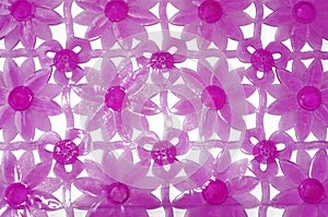 Purple rubber mat for bath with flower pattern as background