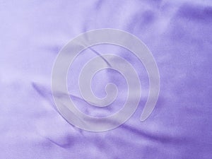 Purple satin textured background with crease