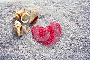 Purple sea solt with seashells and red heart