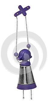 Purple and silver tea infuser in the shape of a girl on a chain. Tea kettles hanging.