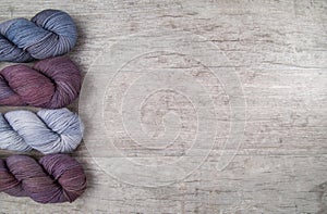 Purple skeins on a wood table