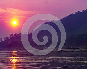 Purple skies with orange sunset over Mekong River