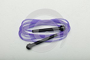 Purple skipping rope on a white background