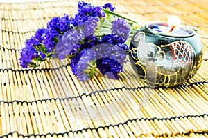 Purple statice with candle light on bamboo background