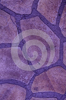 Purple stone wall background. Rock floor, texture.