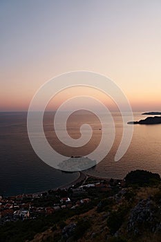 Purple summer sunset over the sea around the island of Sveti Stefan. Montenegro. Top view