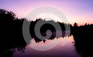 Purple sunset hovers over river