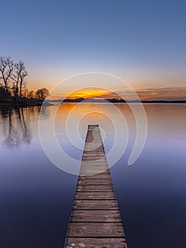 Purple Sunset over Serene Lake vertical