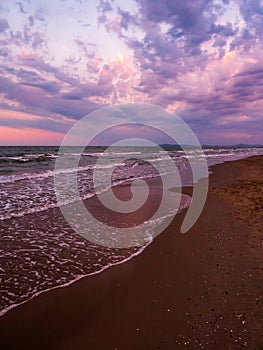 Purple sunset on the sandy beach