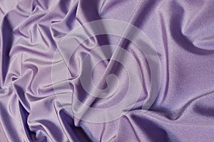 Purple supplex crumpled or wavy fabric texture background. Abstract linen cloth soft waves. Silk fabric. Smooth elegant