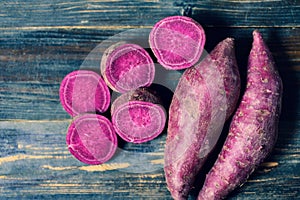 Purple sweet potatoes on wooden