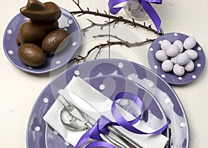 Purple theme Easter dinner, breakfast or brunch table setting, aerial view.