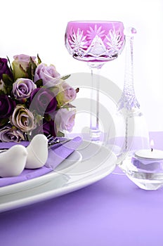 Purple theme wedding table place setting.