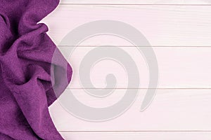 Purple towel over wooden table