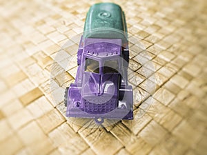 Purple toy truck isolated on a blurred background