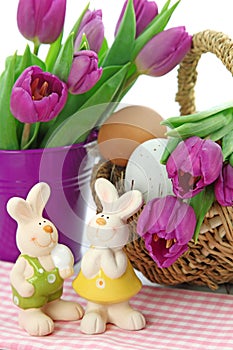 Purple tulips in bucket and two rabbits
