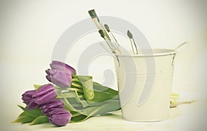 Purple tulips and paintbushes