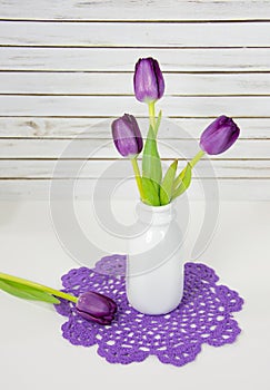 Purple tulips in retro bottle