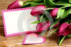 Purple tulips on a wooden background